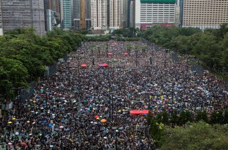 Hong Kong protesters flood city streets in 'peaceful' march