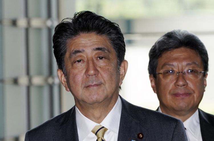 Japan's Abe shakes up cabinet, brings in rising star