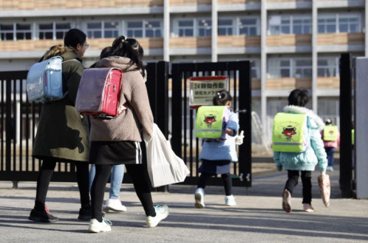 Japan PM defends school closure plan despite critics