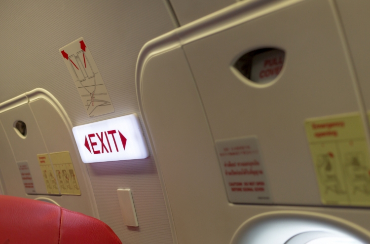 Airplane emergency exit seats to be assigned to uniformed personnel first