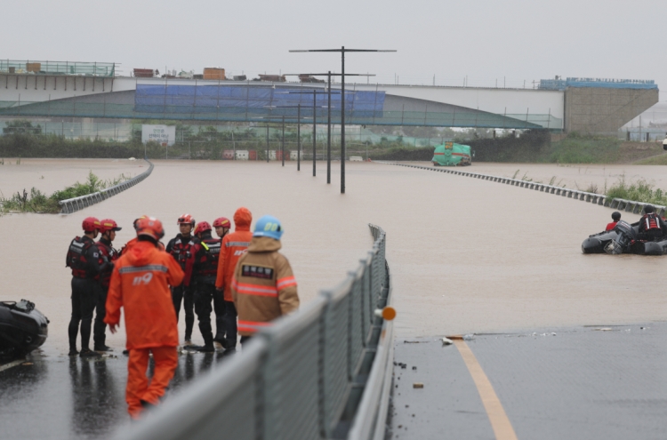 Rescuers desperately trying to reach people trapped in flooded tunnel