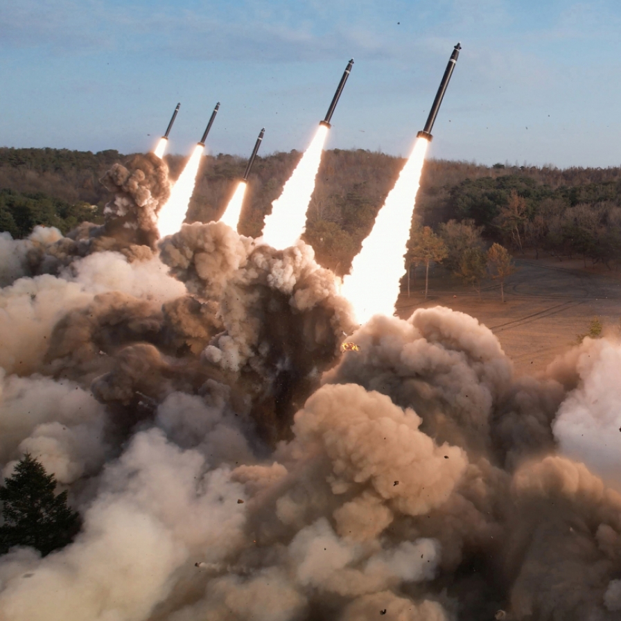 NK leader guides firing drills involving super-large multiple rocket launchers