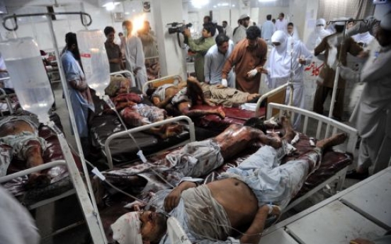 Blasts kill 34 in Pakistan, as CIA chief visits