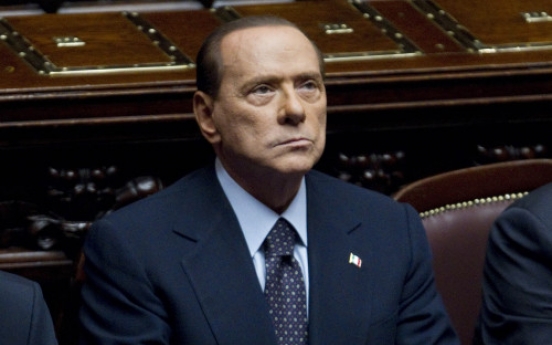 Defiant Berlusconi taken down by markets