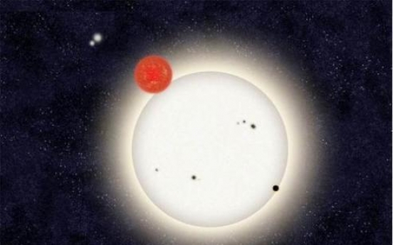 Distant planet found circling with 4 stars