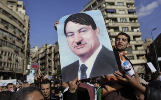 A portrait of Mubarak with moustache and hair to represent Hitler