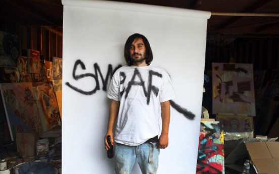Graffiti artist puts tagging behind him