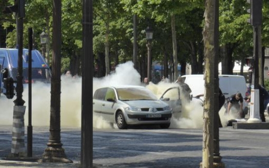 Car rams police vehicle on famed Paris avenue; attacker dies