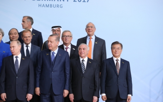 Why was Moon standing in the far corner in G-20 summit photo?