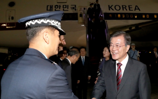 Moon returns home after Russia visit