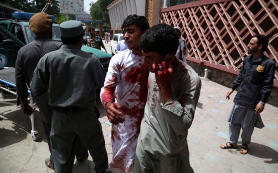 At least nine dead as bomb, gun battle rages in Afghan city