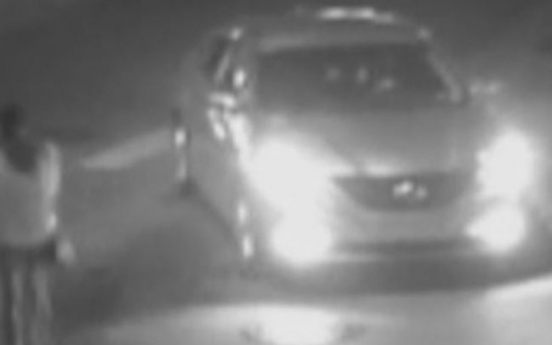 Suspect caught on CCTV ramming car into woman twice