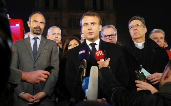 As Notre Dame smolders, Macron vows to rebuild