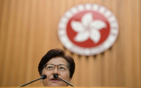 Hong Kong leader insists she will stay on