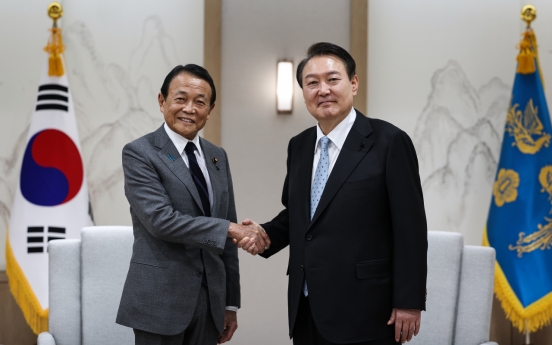 Yoon asks former Japanese PM Aso to help promote development of bilateral ties