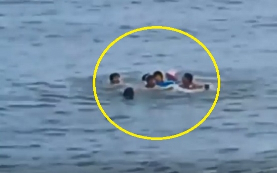 Foreigners rescue grandmother, grandson swept to sea