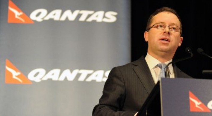 Qantas to slash jobs, cut costs as first-half profit slumps