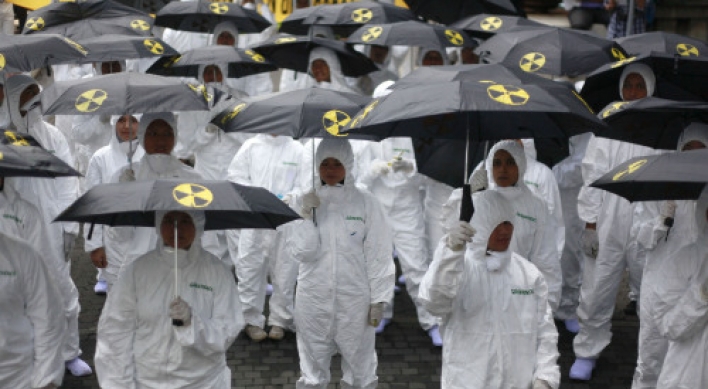 Japan cleans up radiation zone, unsure of success