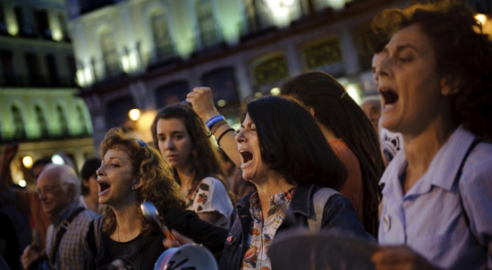 Spain relieved, angry over bank rescue