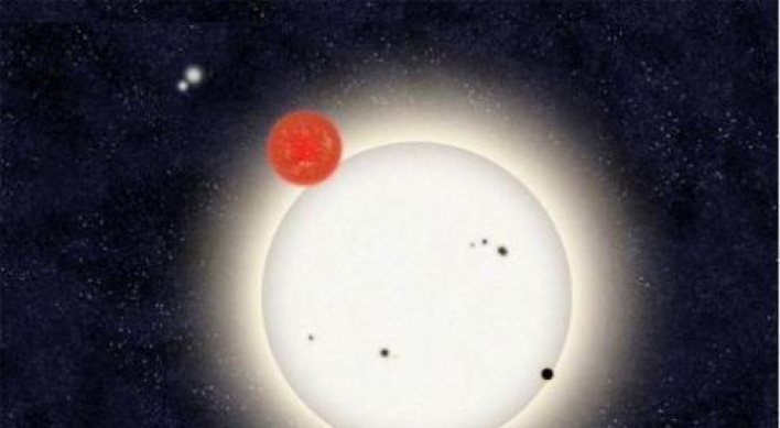 Distant planet found circling with 4 stars