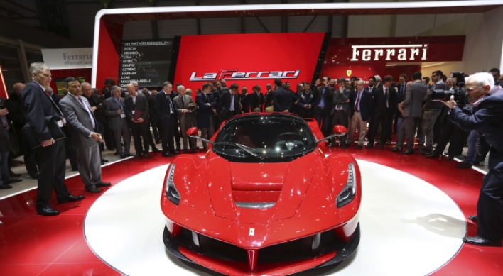 Ferrari, McLaren unveil hybrid supercars