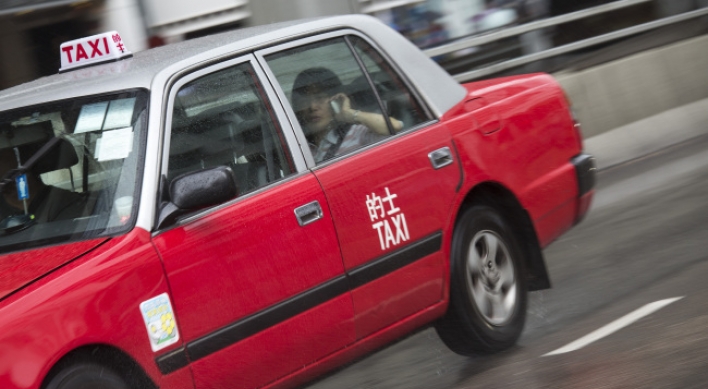 Investors turn H.K.’s red taxis into latest bubble market