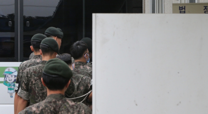 Prosecution files murder charges against 4 soldiers in abuse case