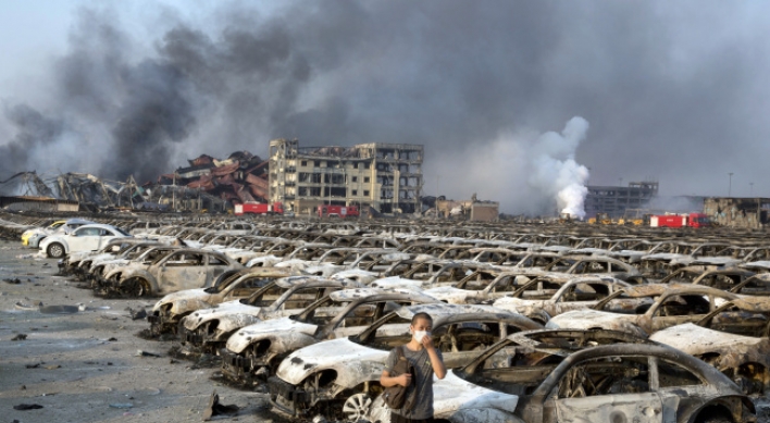 Firefighter rescued from blast zone in China's Tianjin port