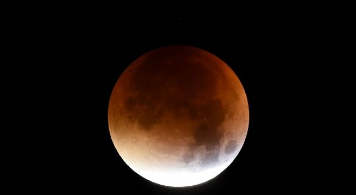 'Super blood moon' shines bright across the world