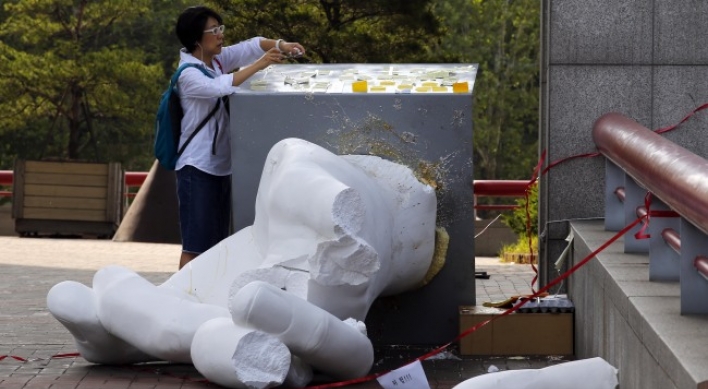 Three booked for destroying controversial sculpture