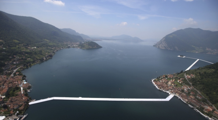 Artist Christo walks on water with “Floating Piers”