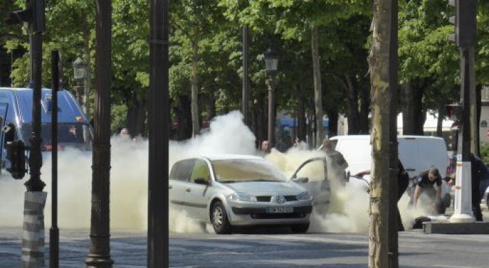 Car rams police vehicle on famed Paris avenue; attacker dies