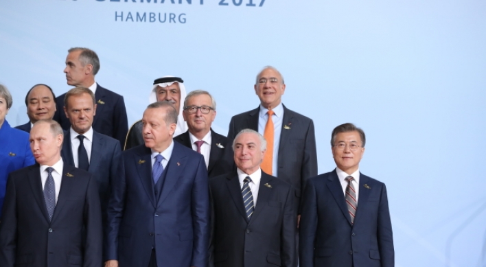 Why was Moon standing in the far corner in G-20 summit photo?