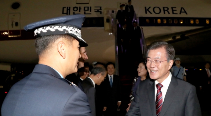 Moon returns home after Russia visit