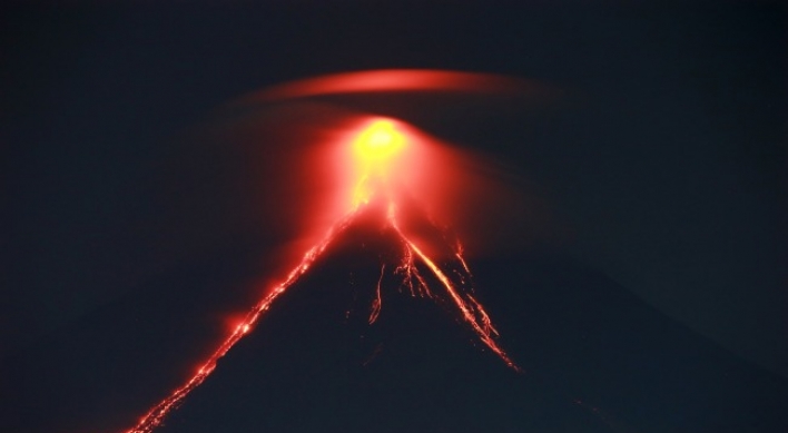 Glowing red lava causes more to flee from Philippine volcano