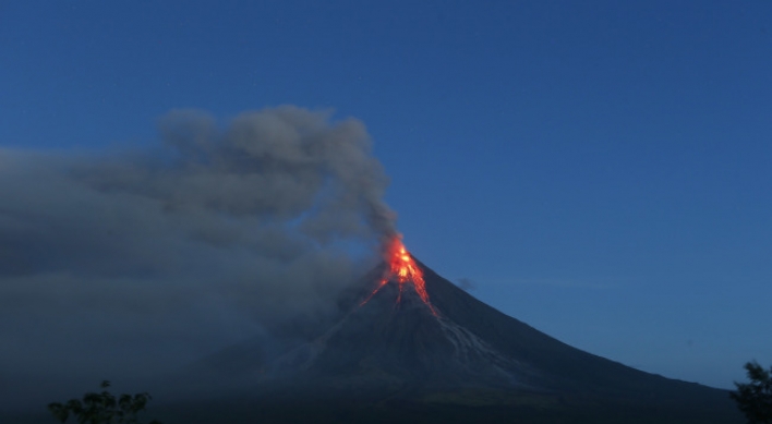 Philippine volcano spews lava fountains, 56,000 people flee