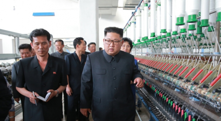 NK leader Kim visits textile plants, chastens workers for not working hard