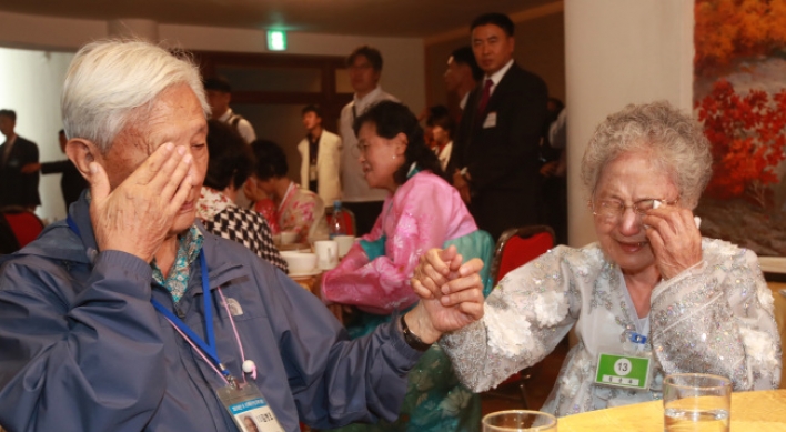 Separated families hold each other one last time