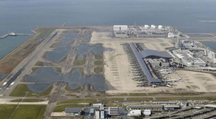 Stranded people leave flooded airport after typhoon in Japan