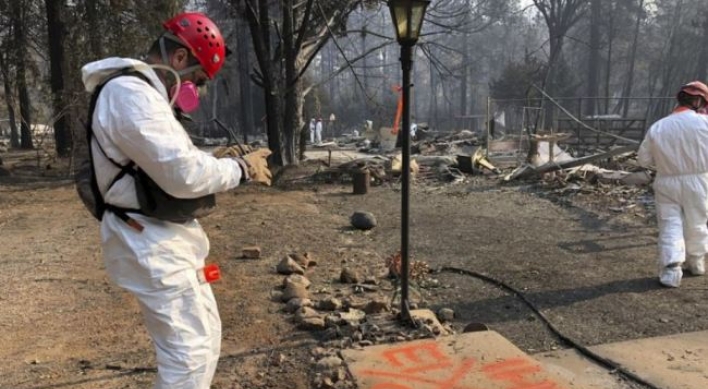 Searchers in California wildfire step up efforts before rain