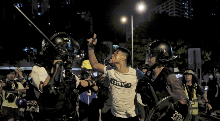 Clashes in Hong Kong after police charge protesters with rioting