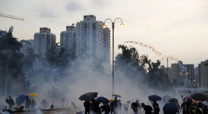 Hong Kong unrest spreads as leader warns city on brink