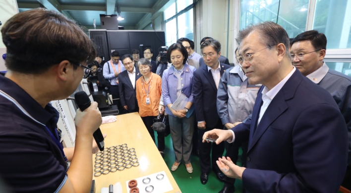 Moon visits high-tech material maker amid trade fight with Japan