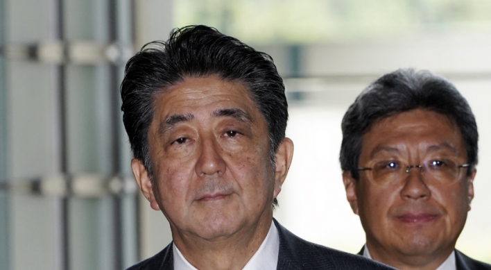 Japan's Abe shakes up cabinet, brings in rising star