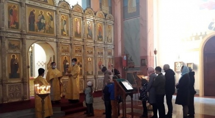 Worshippers, priests wear masks during Mass service in Pyongyang