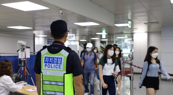 Police patrolling Jeju Airport to fight COVID-19 as more tourists visit the island