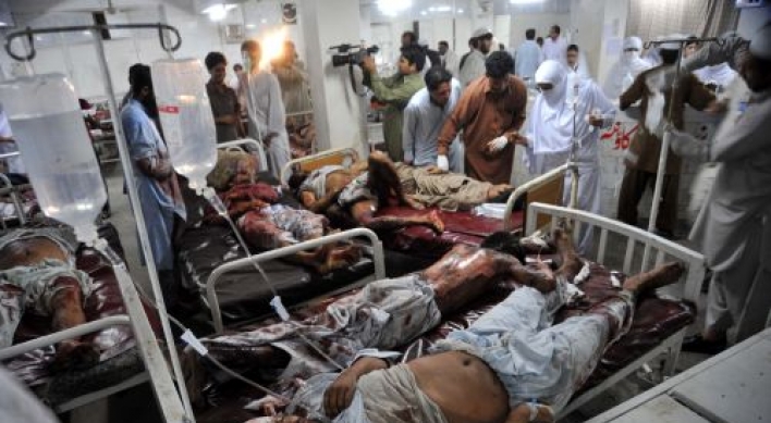 Blasts kill 34 in Pakistan, as CIA chief visits