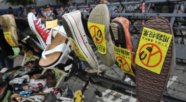 Protesters hurl shoes as Taiwan's ruling party meets