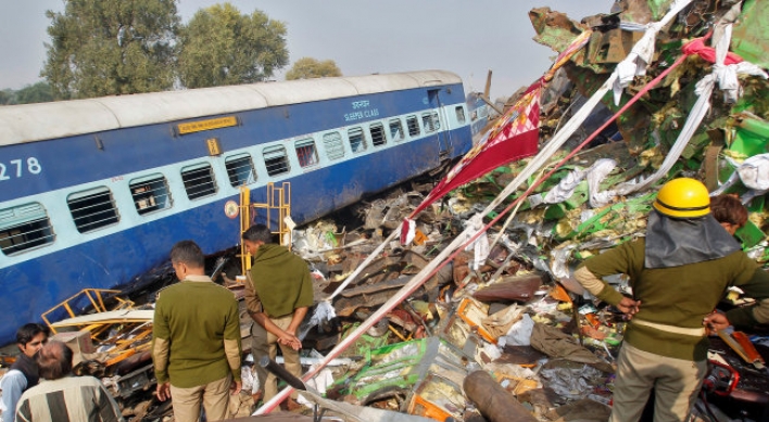 Train derails in north India, killing 104; many trapped