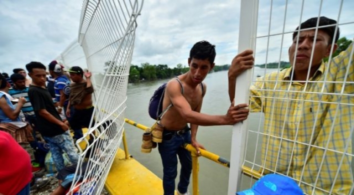 Mexico allows caravan women, children in, but thousands still stranded
